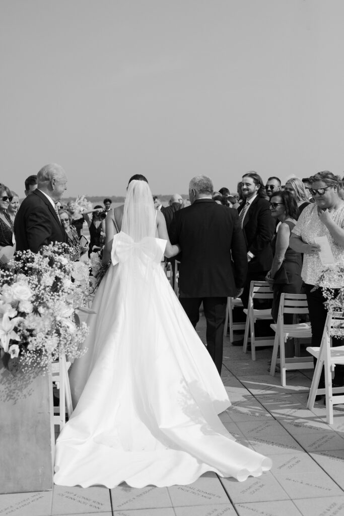 bride walking down the aisle with her father at her wedding in madison, wi