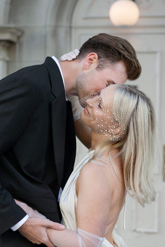 Bride and groom lean in for kiss at their Milwaukee City Hall Elopement.