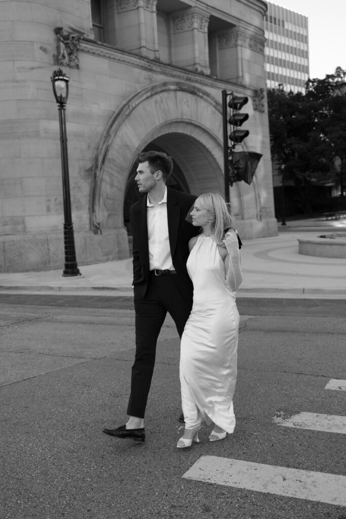 Bride and groom walking on cross walk at their Milwaukee City Hall Elopement.