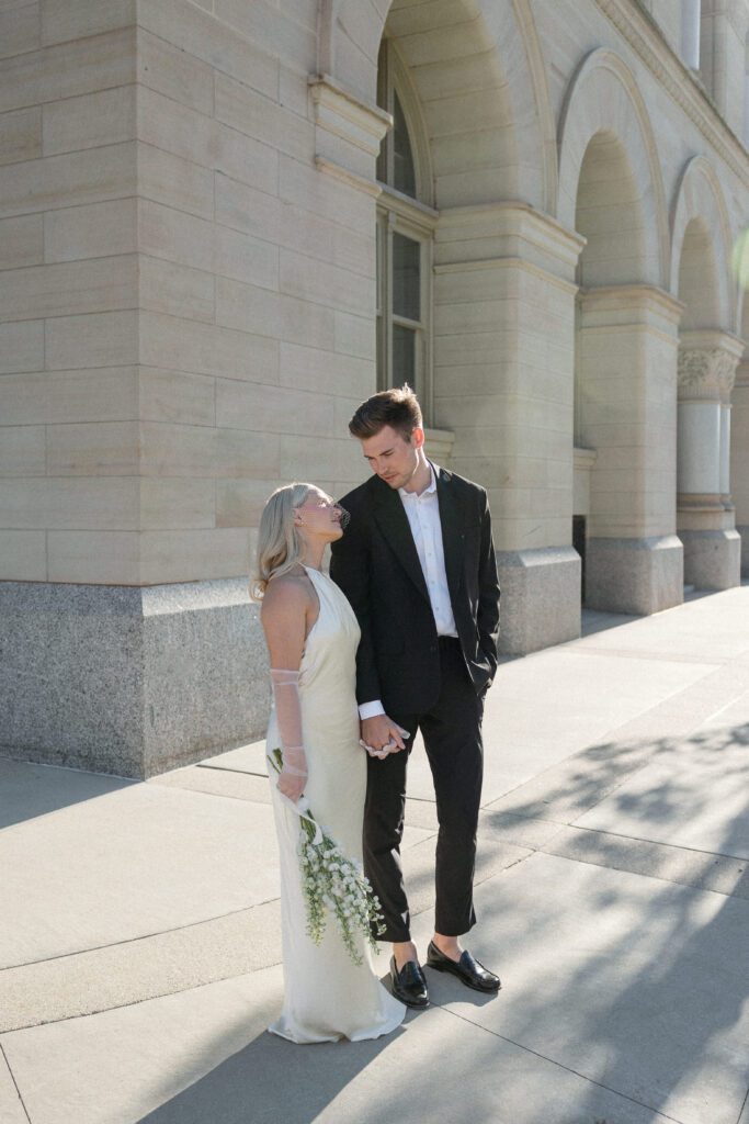 Newlyweds captured outside Milwaukee City Hall, blending love and history.