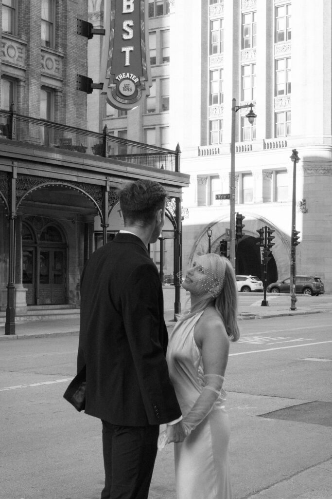 A romantic moment as the couple stands at Milwaukee City Hall.