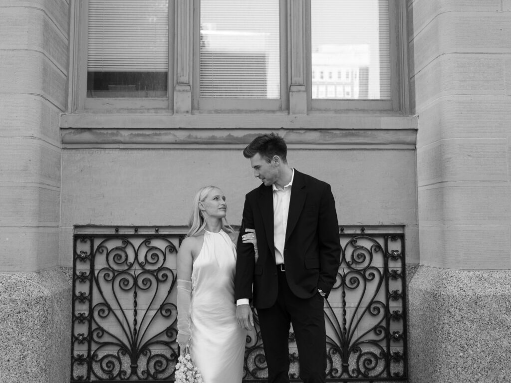 Milwaukee City Hall elopement featuring a joyful bride and groom outside the historic landmark.