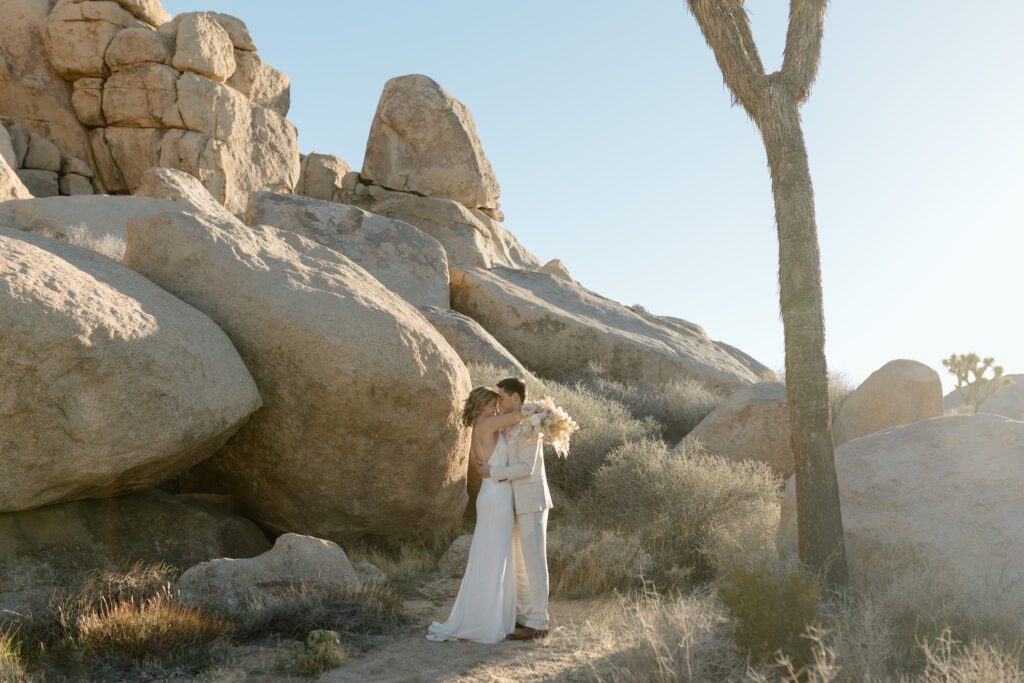 Dreamy desert elopement with bride and groom in Joshua Tree by Mariah Jones Photo wedding dress neutral florals documentary