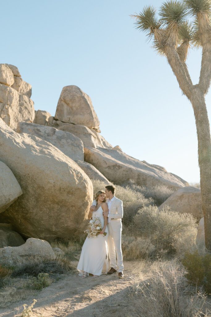 Dreamy desert elopement with bride and groom in Joshua Tree by Mariah Jones Photo wedding dress neutral florals documentary