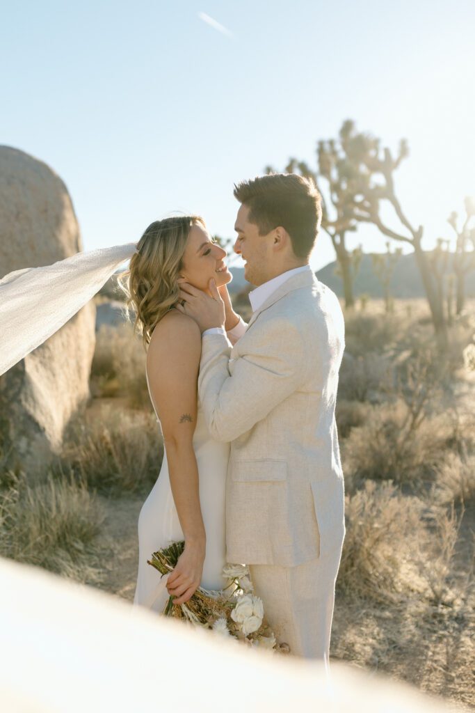 Dreamy desert elopement with bride and groom in Joshua Tree by Mariah Jones Photo wedding dress neutral florals documentary