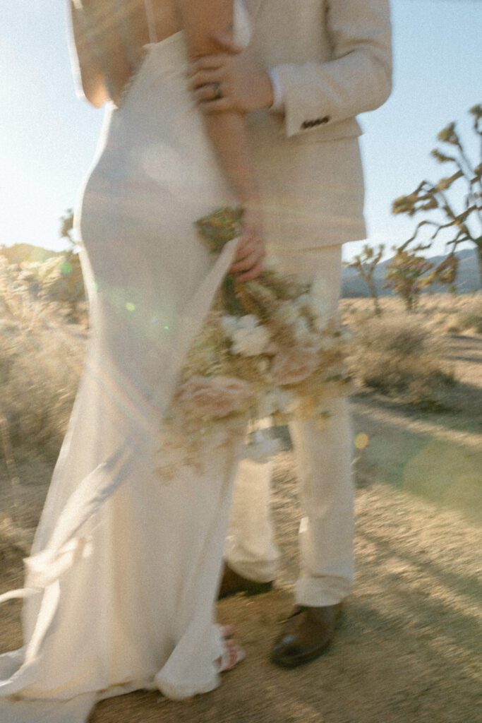 Dreamy desert elopement with bride and groom in Joshua Tree by Mariah Jones Photo wedding dress neutral florals documentary