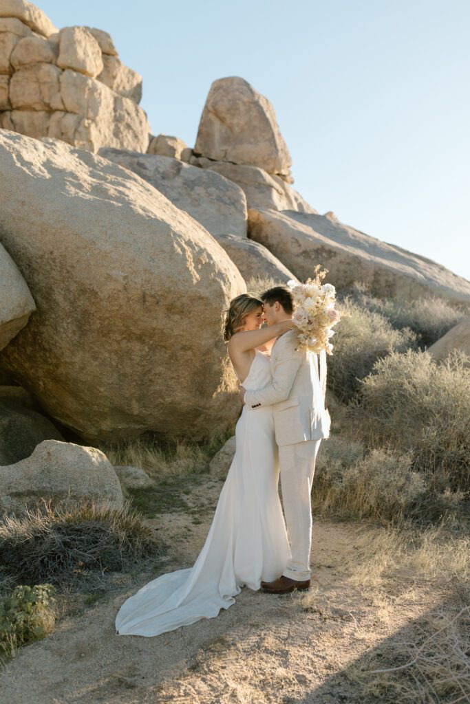 Dreamy desert elopement with bride and groom in Joshua Tree by Mariah Jones Photo wedding dress neutral florals documentary