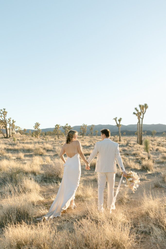 Dreamy desert elopement with bride and groom in Joshua Tree by Mariah Jones Photo wedding dress neutral florals documentary