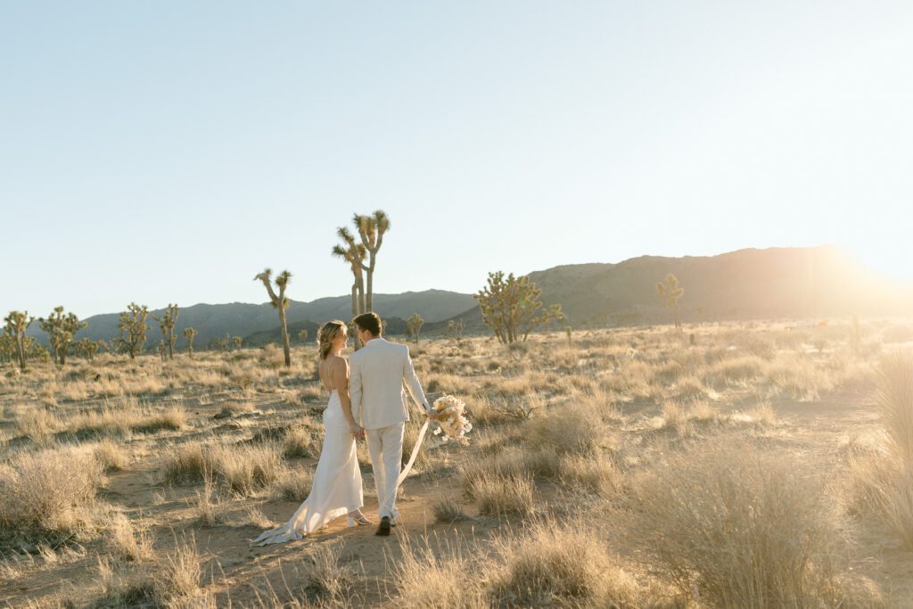 Dreamy desert elopement with bride and groom in Joshua Tree by Mariah Jones Photo wedding dress neutral florals documentary