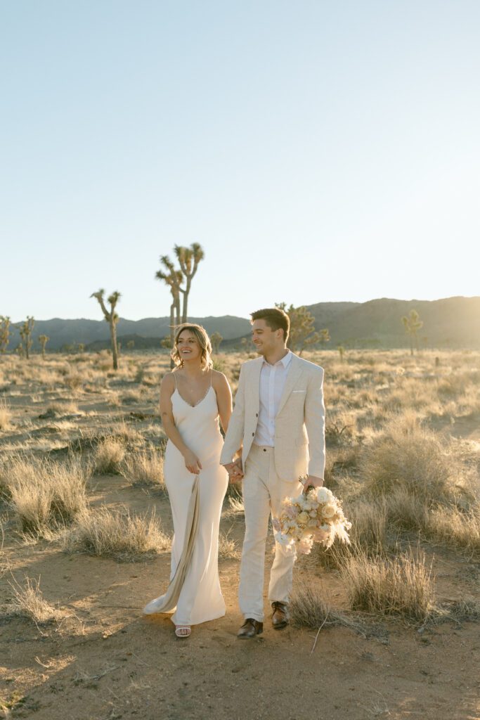 Dreamy desert elopement with bride and groom in Joshua Tree by Mariah Jones Photo wedding dress neutral florals documentary