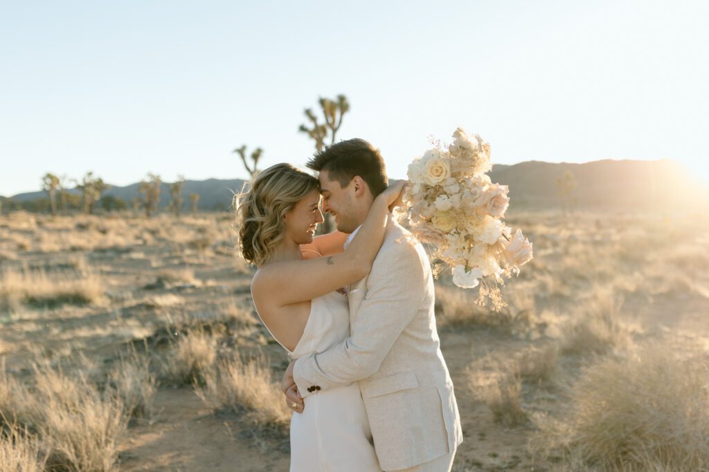 Dreamy desert elopement with bride and groom in Joshua Tree by Mariah Jones Photo wedding dress neutral florals documentary