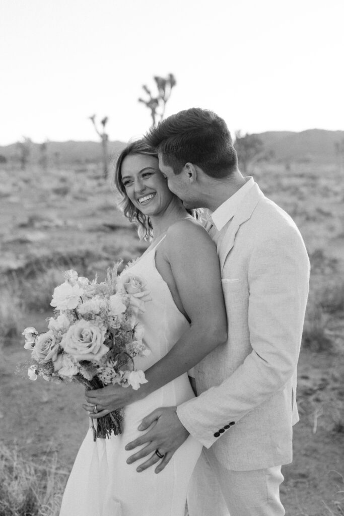 Dreamy desert elopement with bride and groom in Joshua Tree by Mariah Jones Photo wedding dress neutral florals documentary