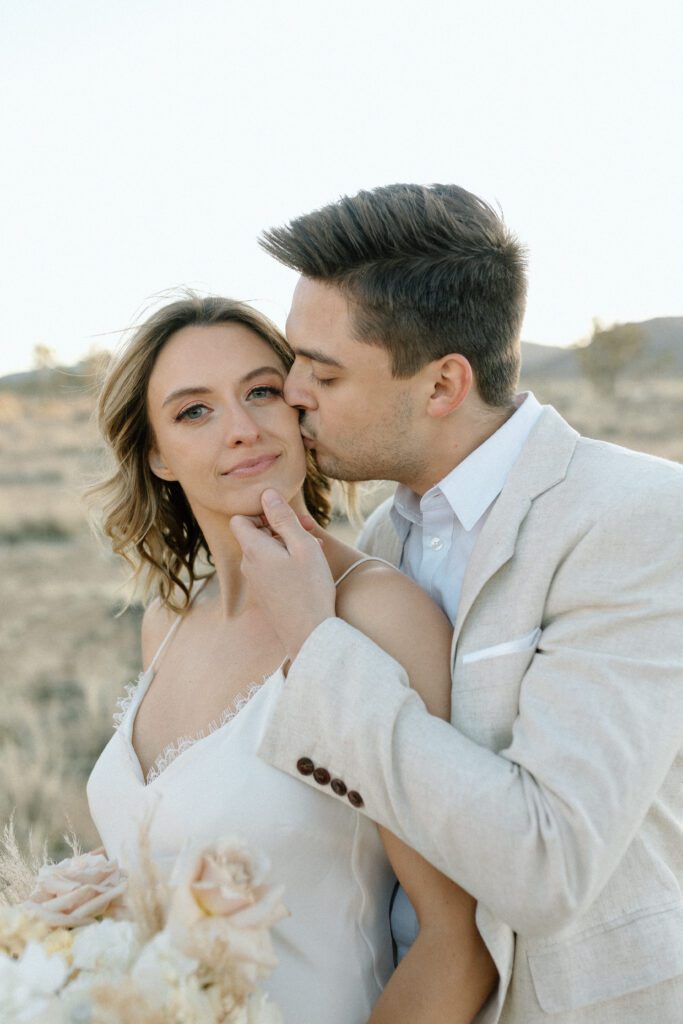 Dreamy desert elopement with bride and groom in Joshua Tree by Mariah Jones Photo wedding dress neutral florals documentary