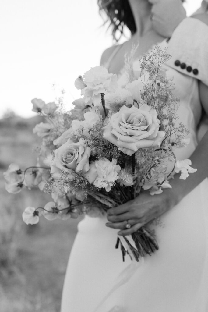 Dreamy desert elopement with bride and groom in Joshua Tree by Mariah Jones Photo wedding dress neutral florals documentary