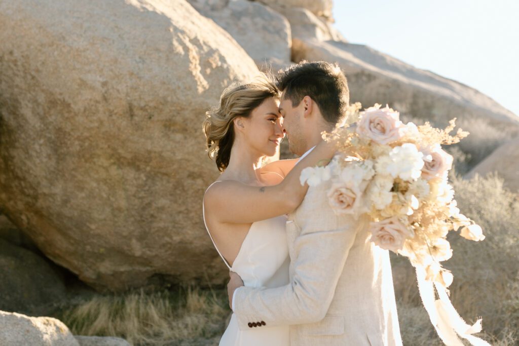 Dreamy desert elopement with bride and groom in Joshua Tree by Mariah Jones Photo wedding dress neutral florals documentary