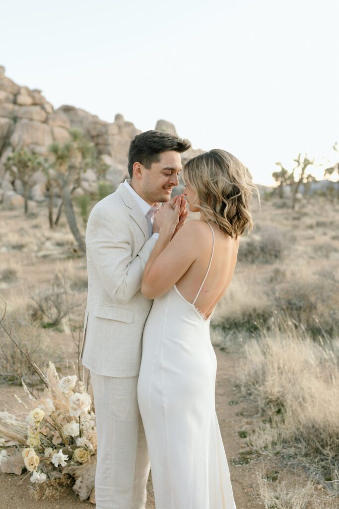 Dreamy desert elopement with bride and groom in Joshua Tree by Mariah Jones Photo wedding dress neutral florals documentary