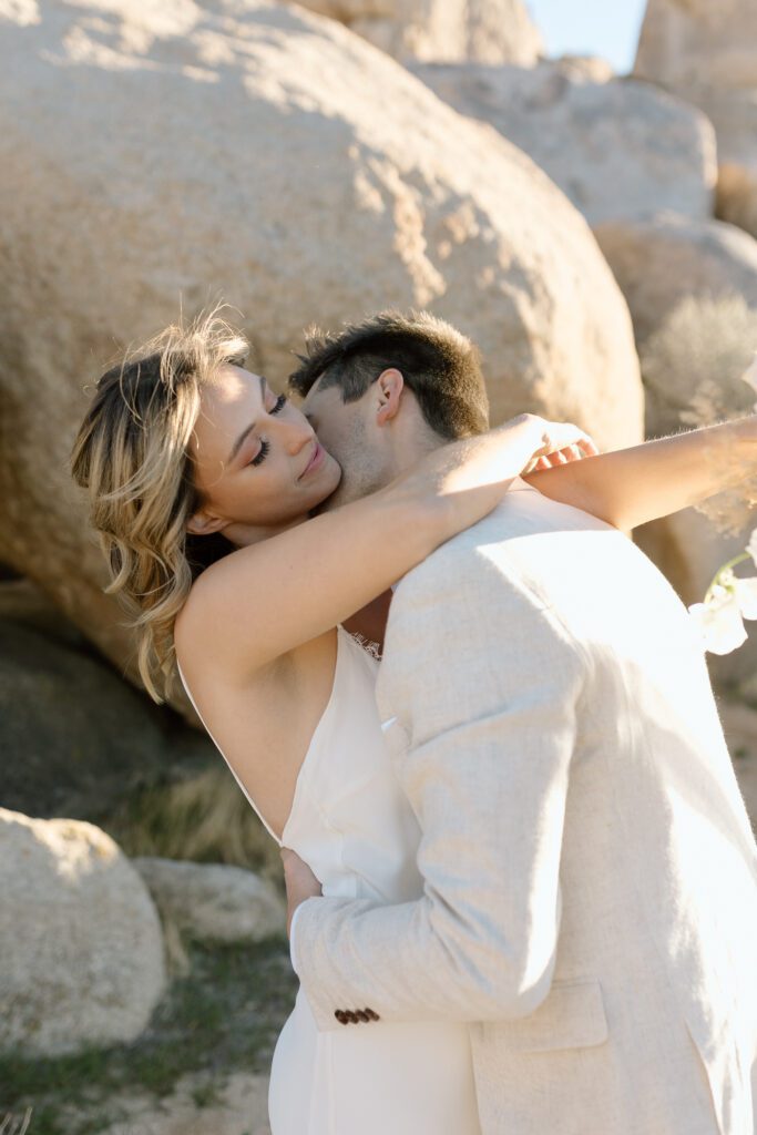 Dreamy desert elopement with bride and groom in Joshua Tree by Mariah Jones Photo wedding dress neutral florals documentary