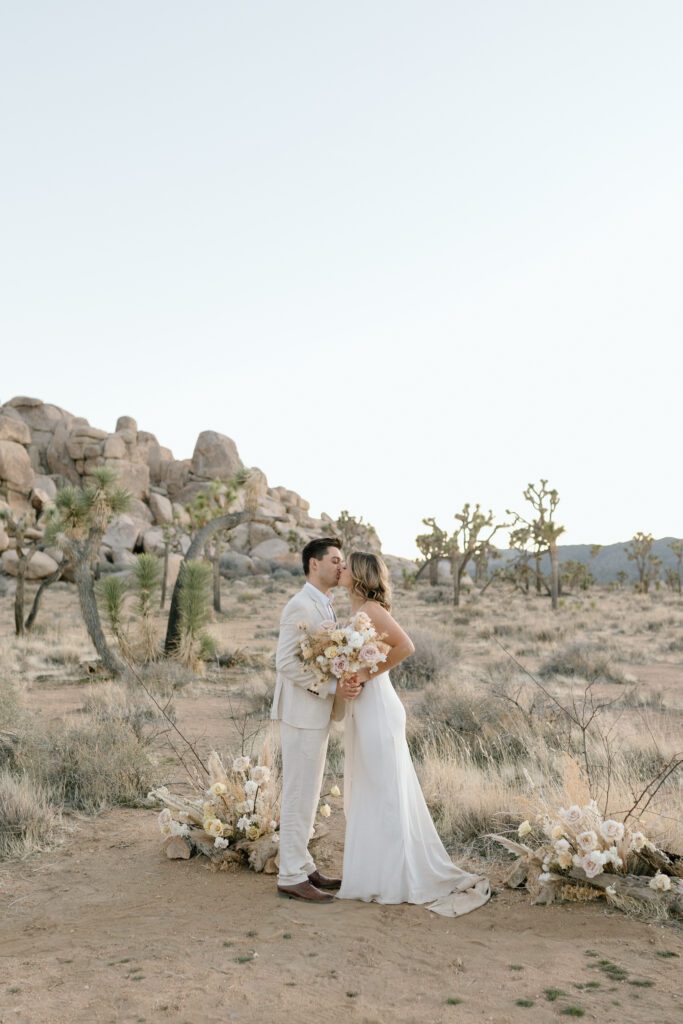 Dreamy desert elopement with bride and groom in Joshua Tree by Mariah Jones Photo wedding dress neutral florals documentary