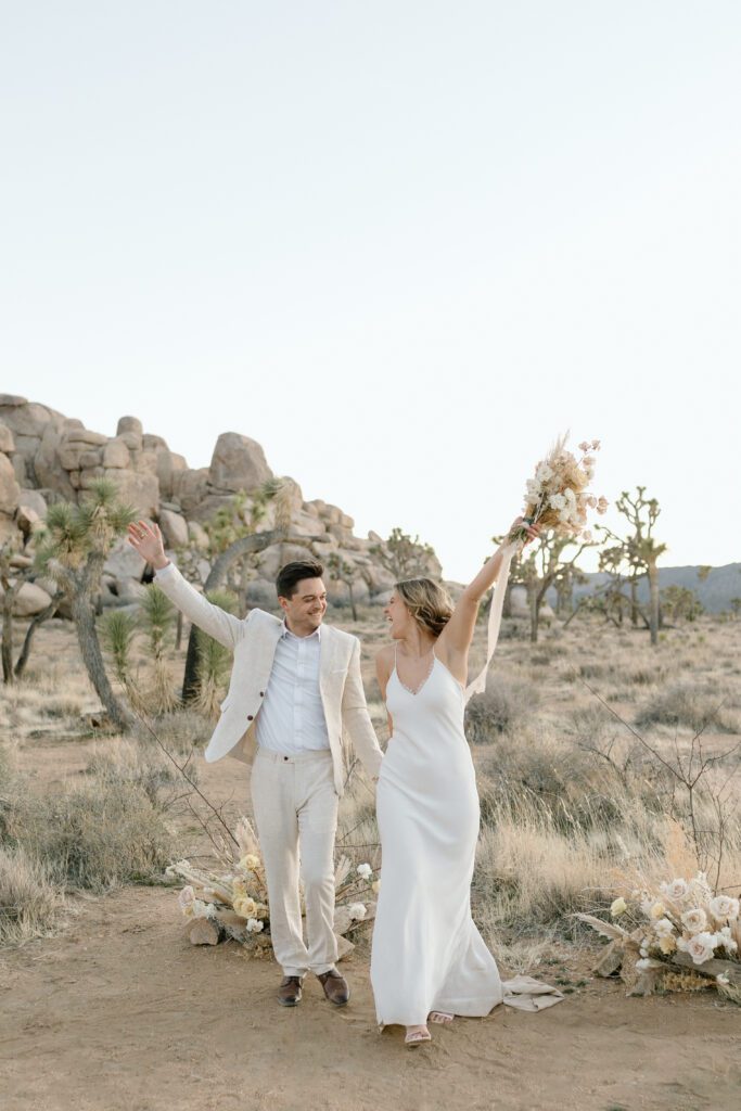 Dreamy desert elopement with bride and groom in Joshua Tree by Mariah Jones Photo wedding dress neutral florals documentary