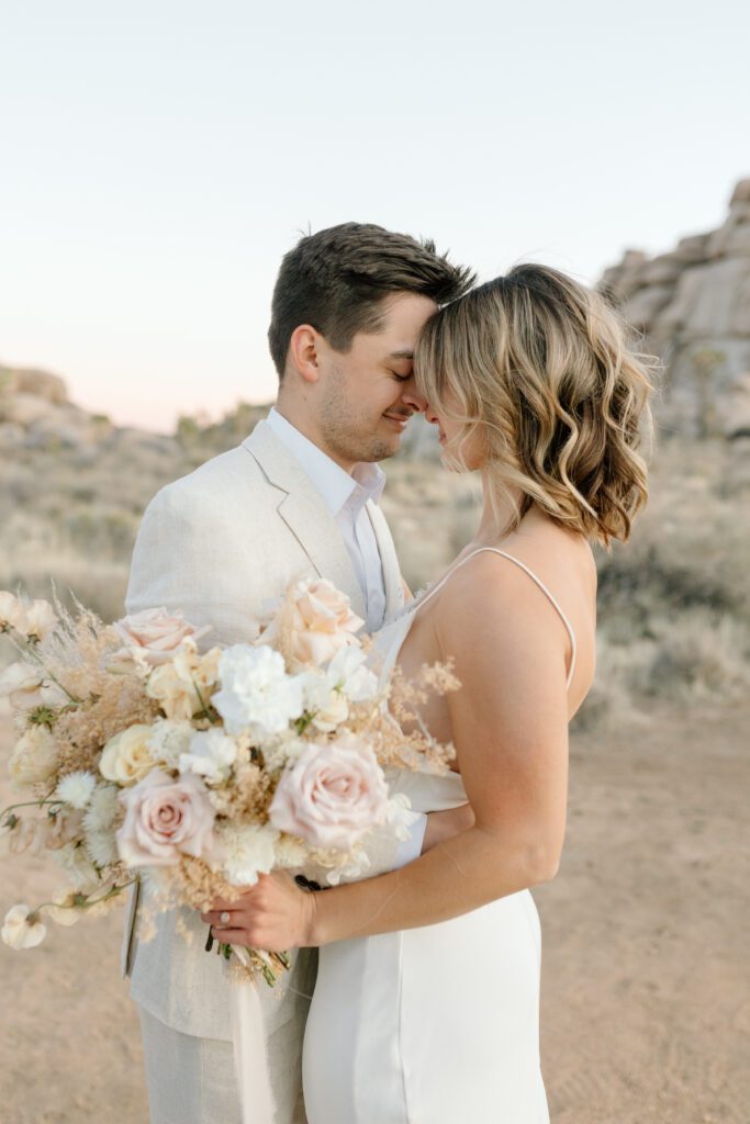 Dreamy desert elopement with bride and groom in Joshua Tree by Mariah Jones Photo wedding dress neutral florals documentary