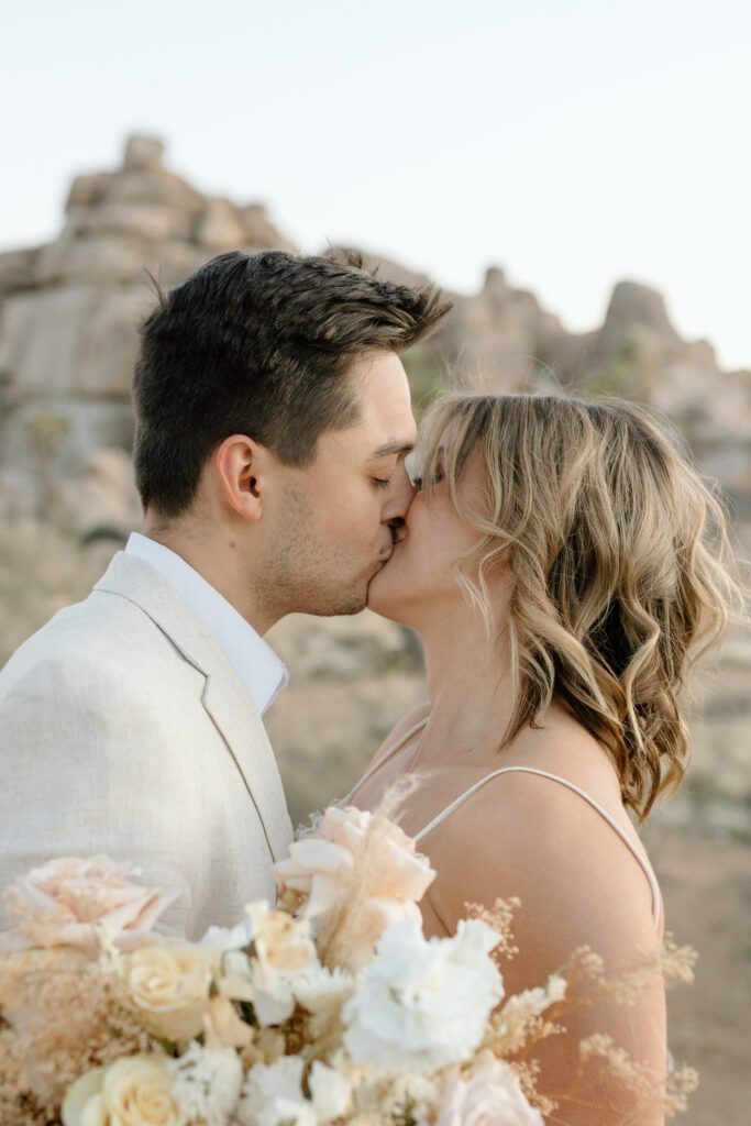 Dreamy desert elopement with bride and groom in Joshua Tree by Mariah Jones Photo wedding dress neutral florals documentary