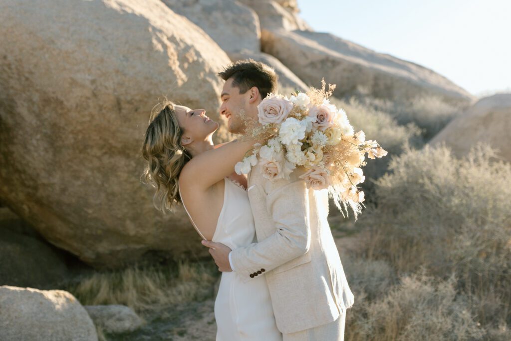 Dreamy desert elopement with bride and groom in Joshua Tree by Mariah Jones Photo wedding dress neutral florals documentary