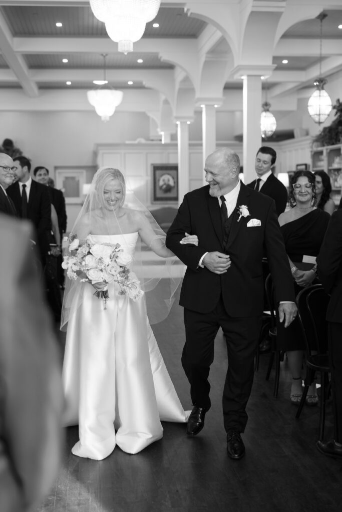 bride walking down aisle during the ceremony at The George and Madcap Lounge