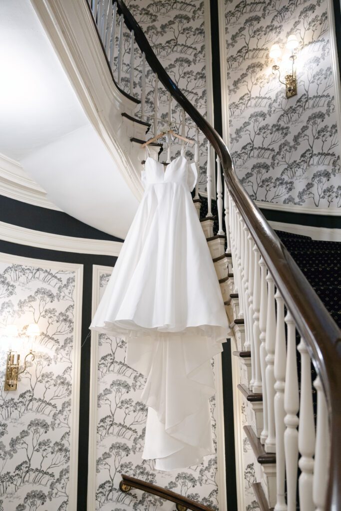 wedding dress hanging from stairs at the Madison club