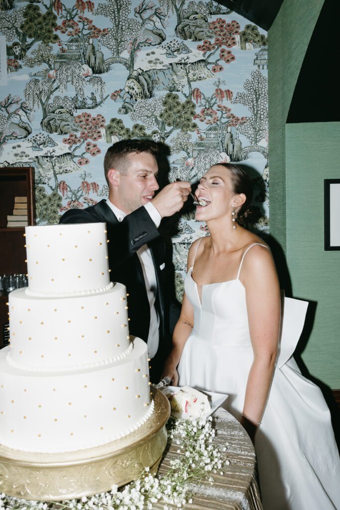 bride and groom cutting cake at The Madison Club for their wedding.