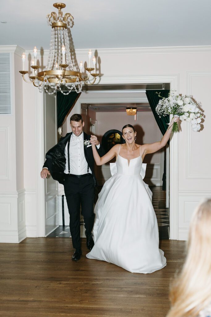 bride and groom entering the reception hall at their madison club wedding