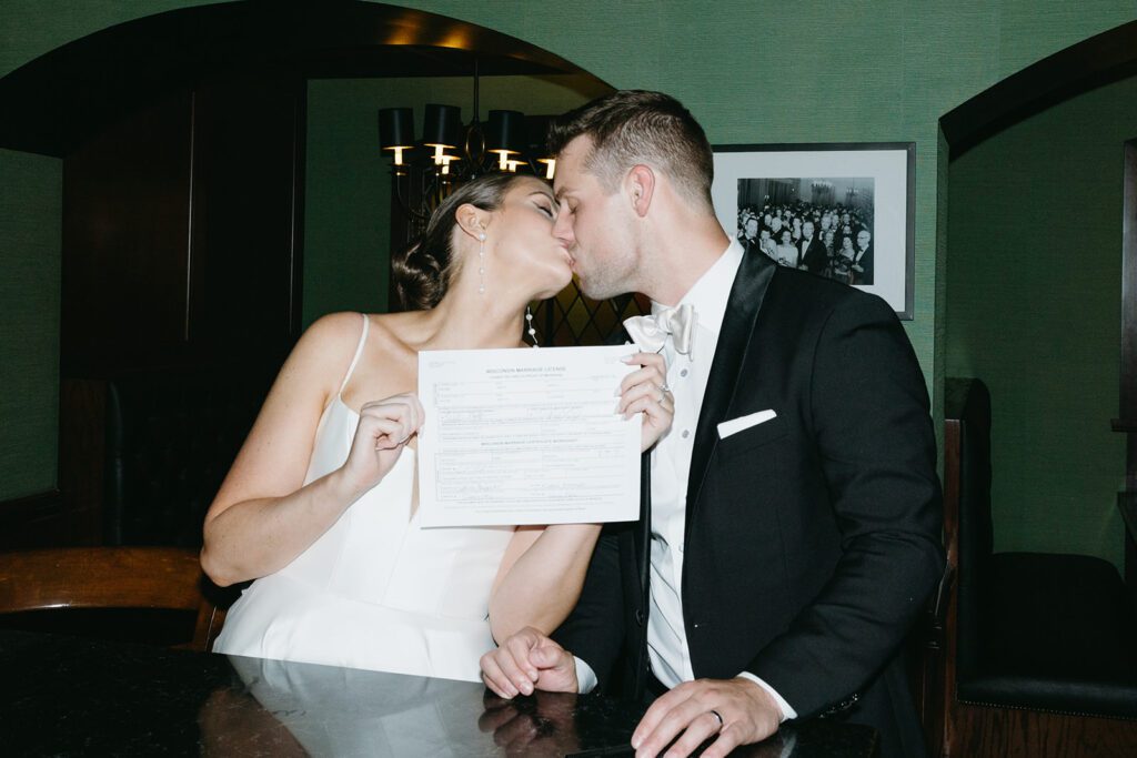 bride and groom signing marriage license at The Madison Club for their wedding.