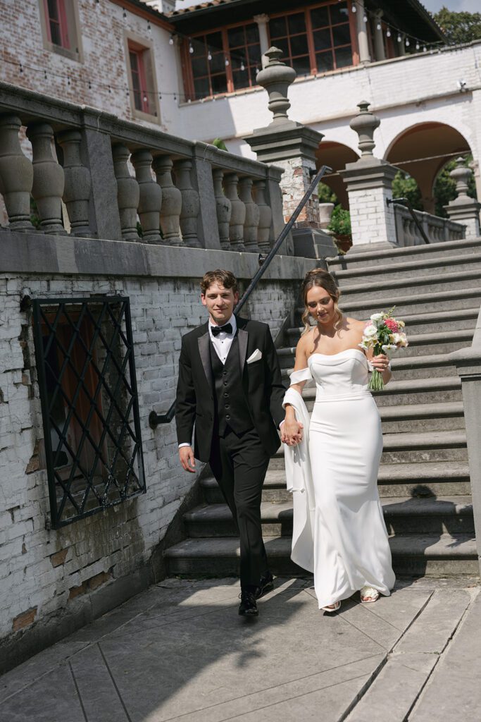 bride and groom walking down steps at their Villa Terrace Decorative Arts Museum wedding