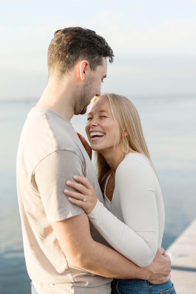 Couple laughing together on the pier at the Memorial Union.