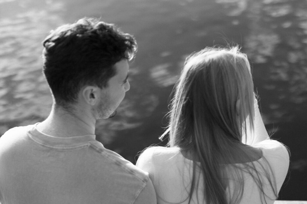 A black and white portrait of the couple admiring Lake Mendota views.