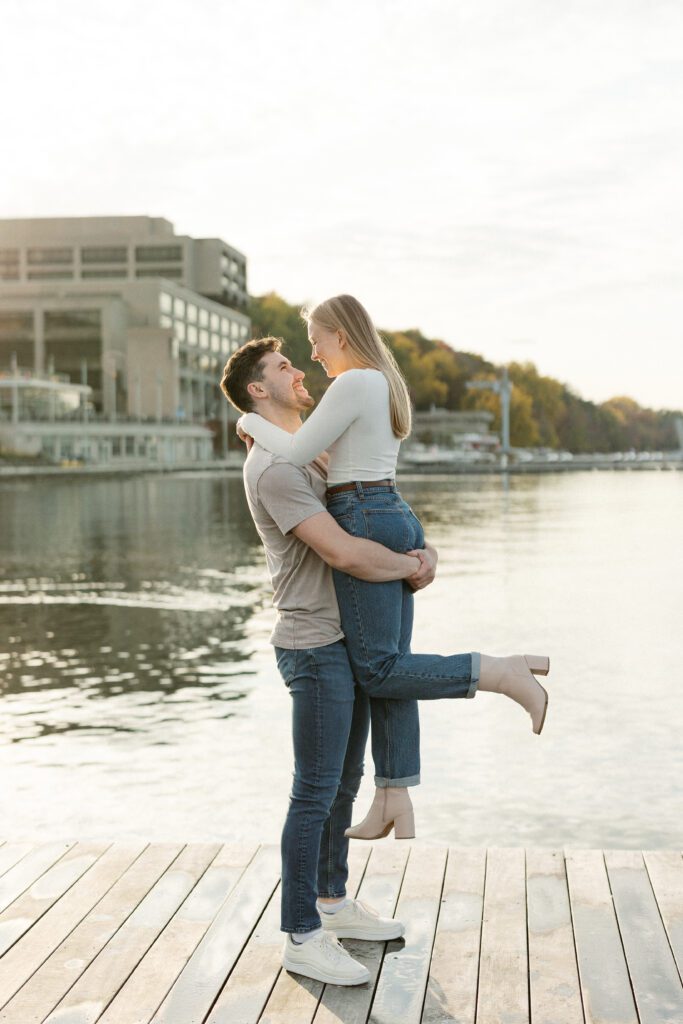 Couple twirling on the pier at their Memorial Union engagement session.