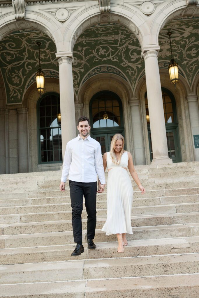 Engaged couple walking hand-in-hand at the Memorial Union.