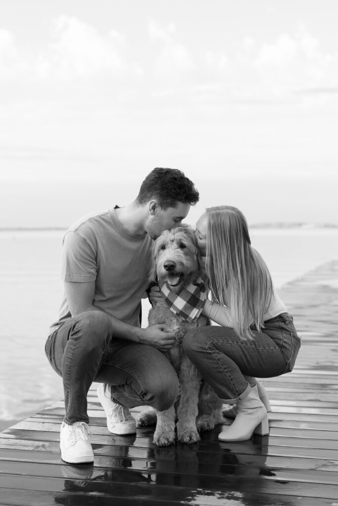 Engaged couple with their dog at the Memorial Union.