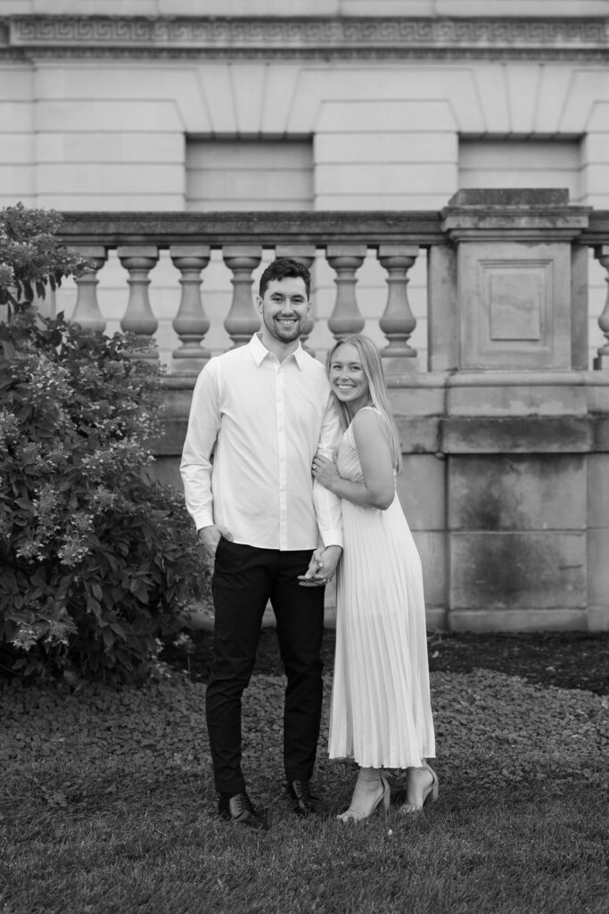 Couple smiling softly as they embrace in a portrait