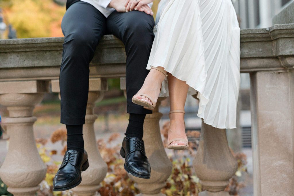 Close up of couple's feet dangling off edge.