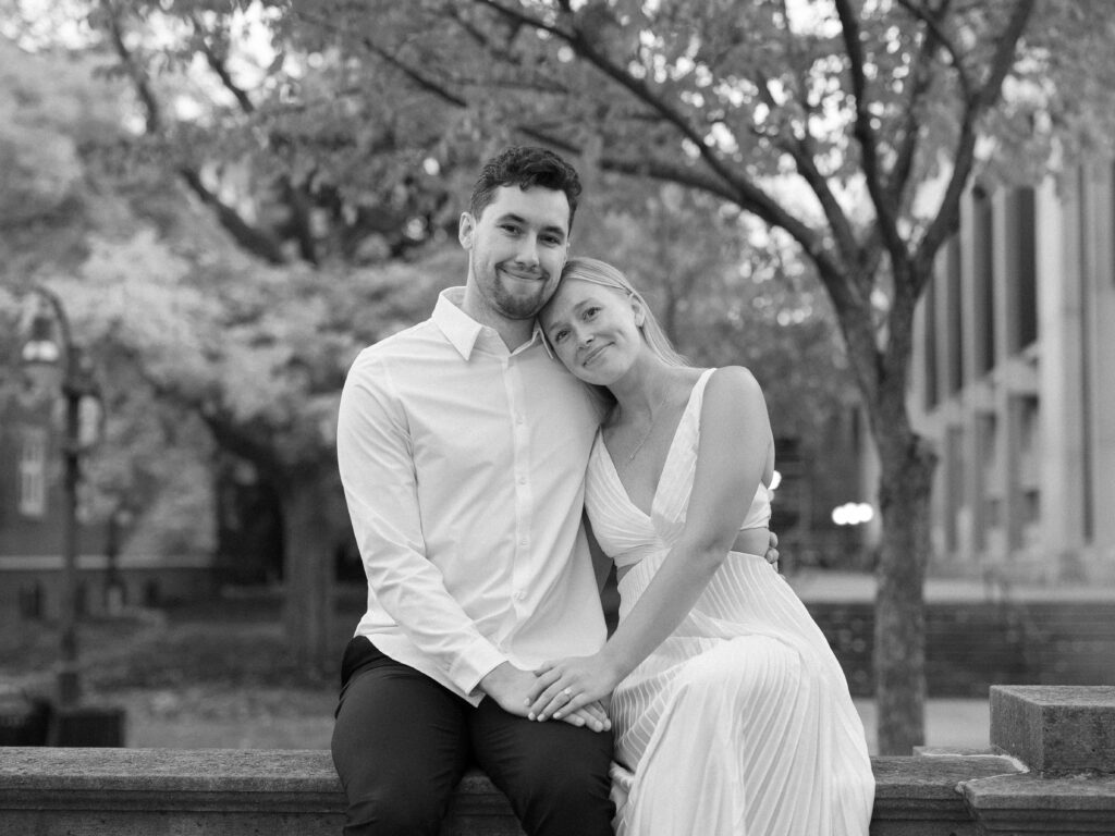 Engaged couple sitting hand in hand enjoying a moment together.