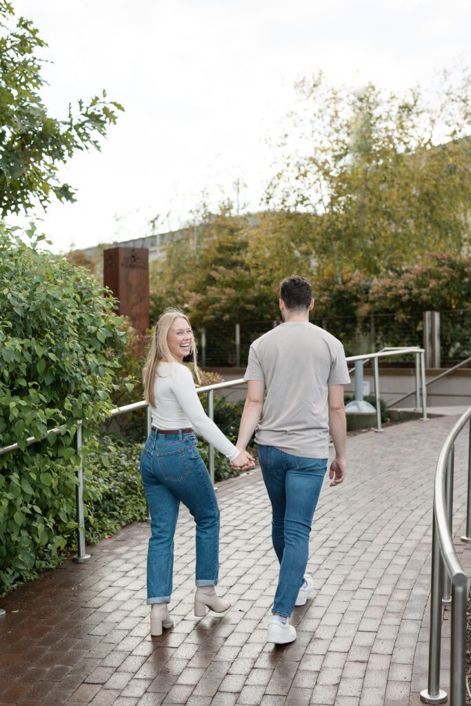 Couple walks hand in hand at their Madison engagement session.