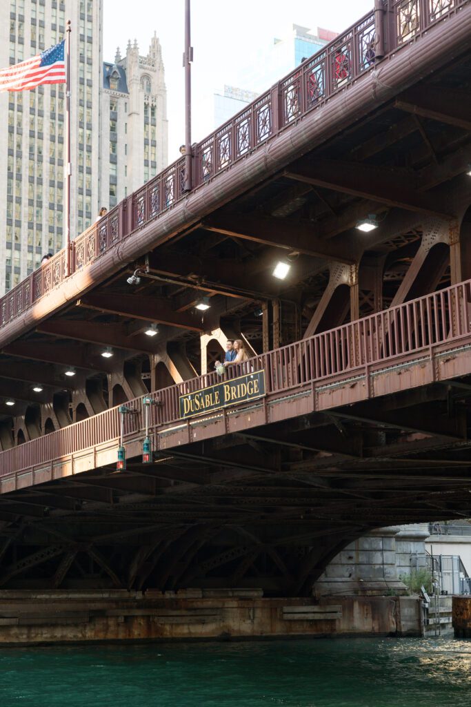 Couple looking over a railing together at their North Avenue Beach Chicago engagement session.