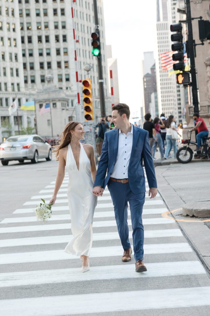 Couple walking in a cross walk during their Chicago engagement session.