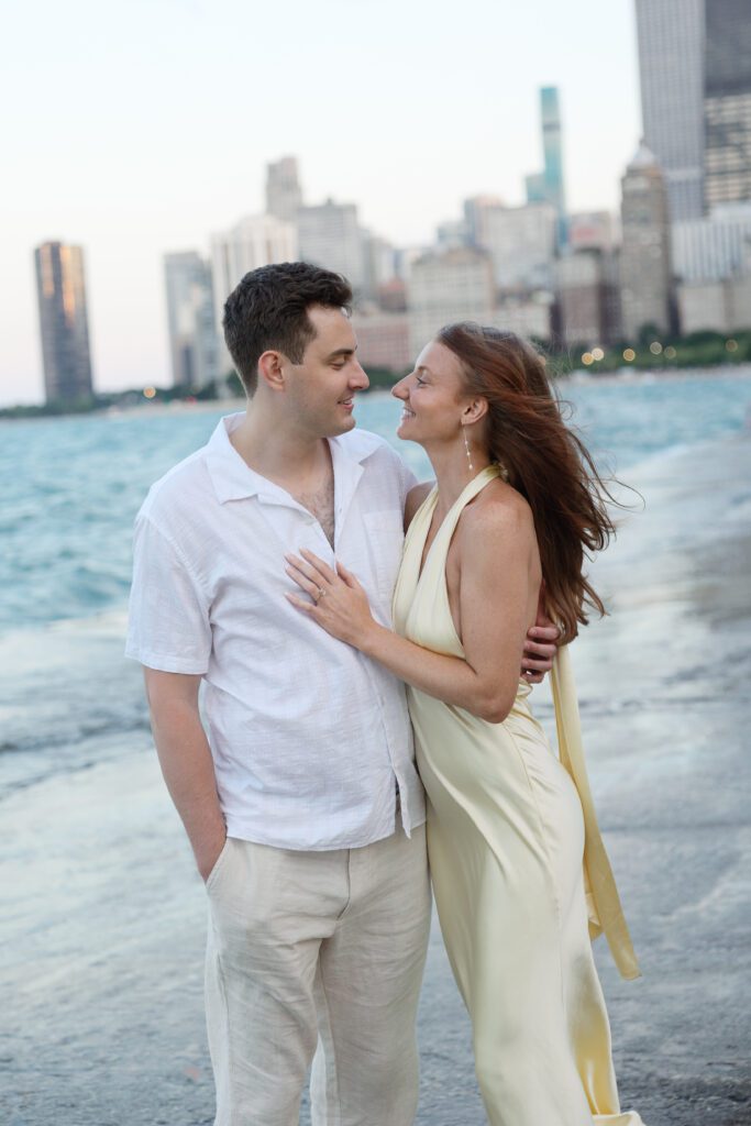 Couple walking together during their engagement session at North Avenue Beach.