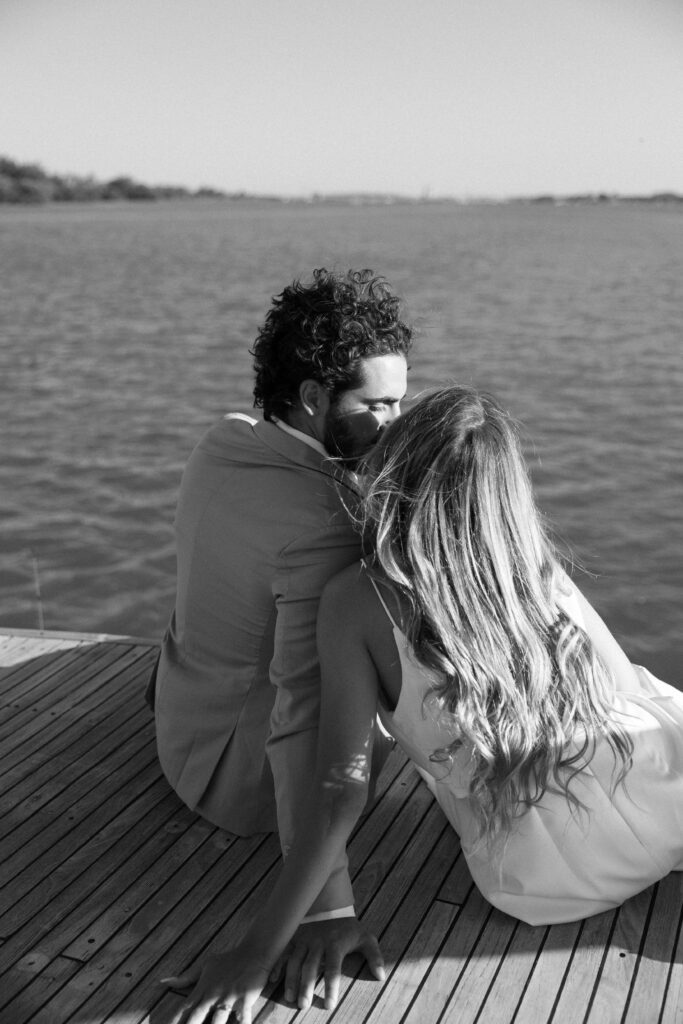 A close-up of the couple snuggling together, with the sun setting in the background, capturing the essence of their love during the West Palm Beach Boat Elopement.