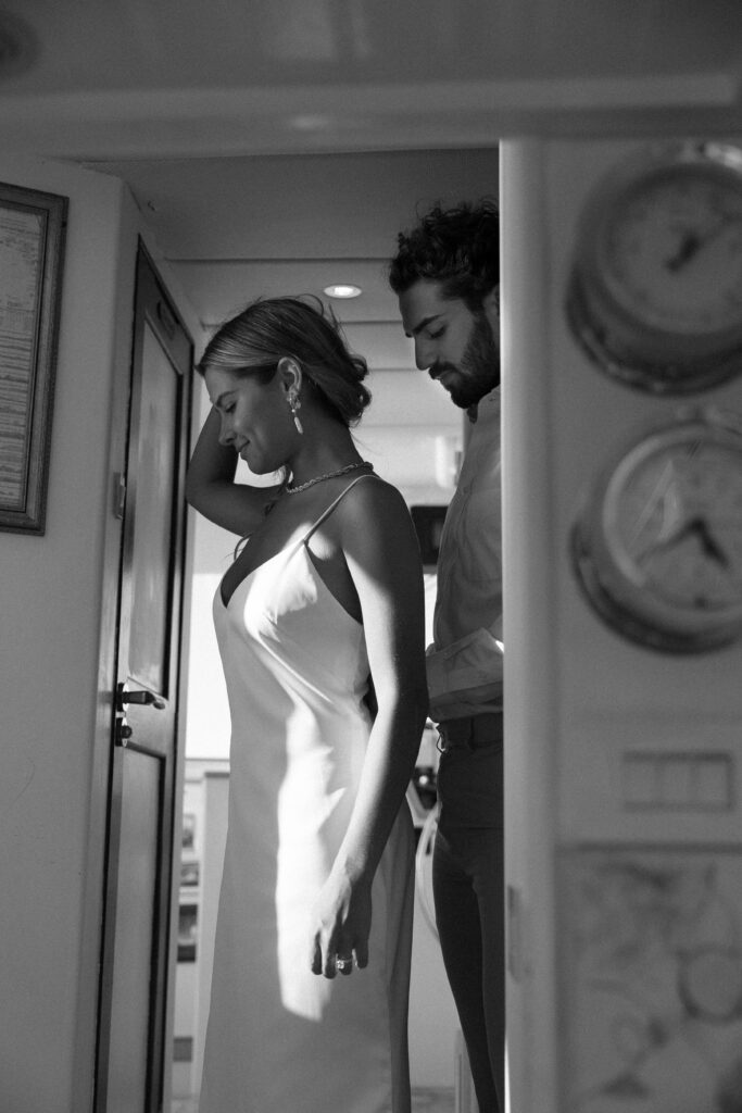 The bride and groom sharing a quiet moment in the yacht's cabin before their West Palm Beach Boat Elopement ceremony.