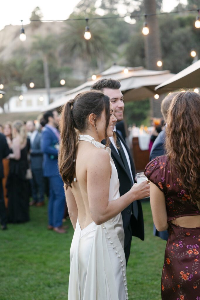 Bride and groom enjoying their cocktail hour at a Bel Air Bay Club wedding.