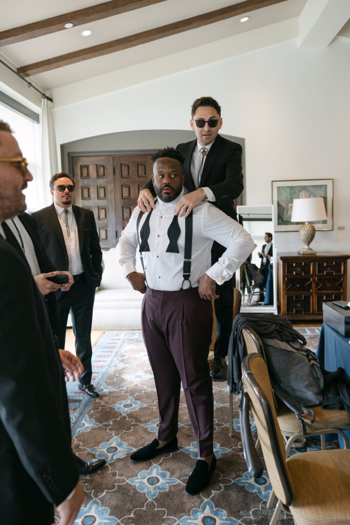 Groom getting ready with his groomsmen at the Bel Air Bay Club.