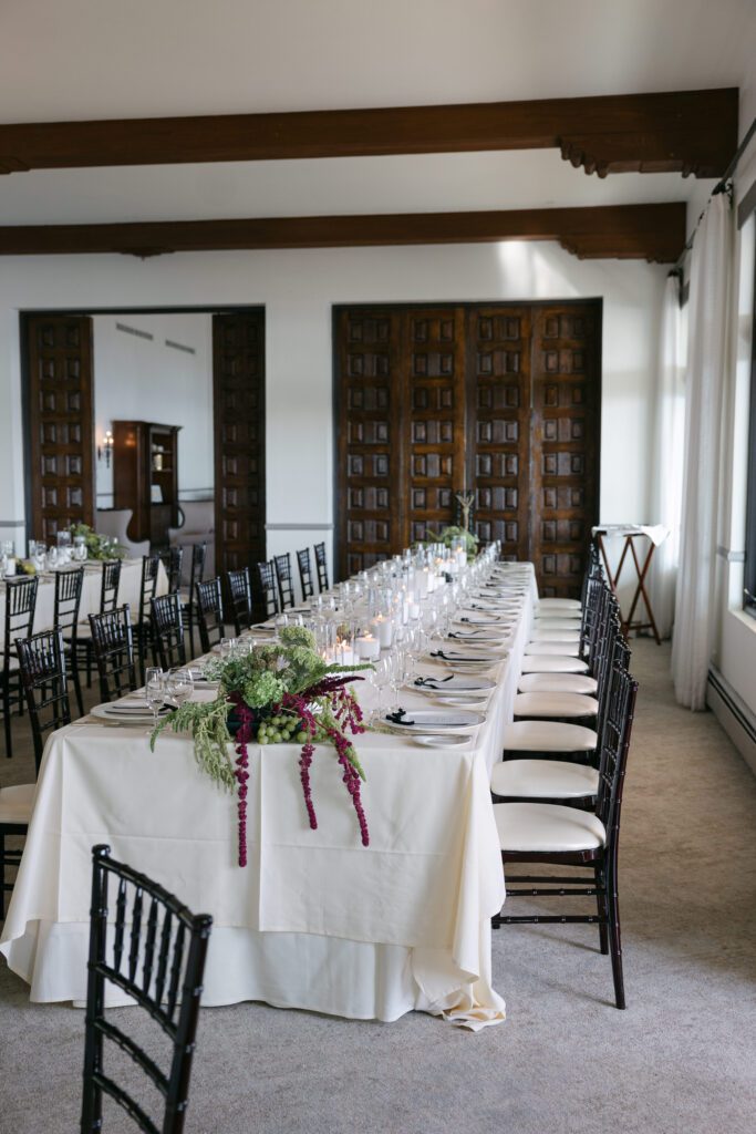 Elegant reception setup at a Bel Air Bay Club wedding, featuring candlelit tables and ocean views at sunset.