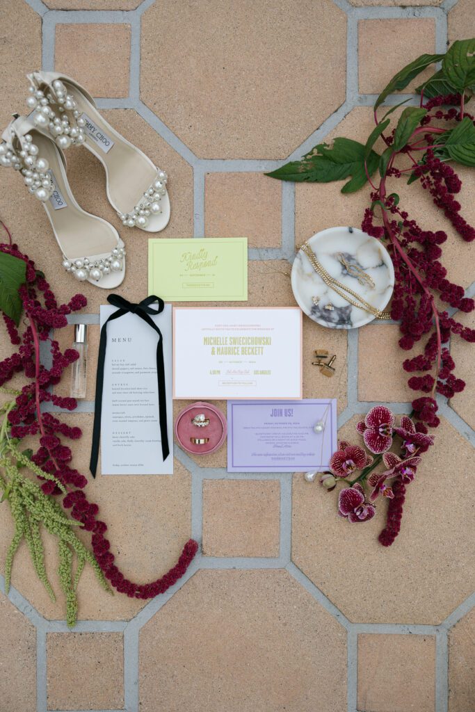 Invitation flat lay on the terrace on a Bel Air Bay Club wedding day.